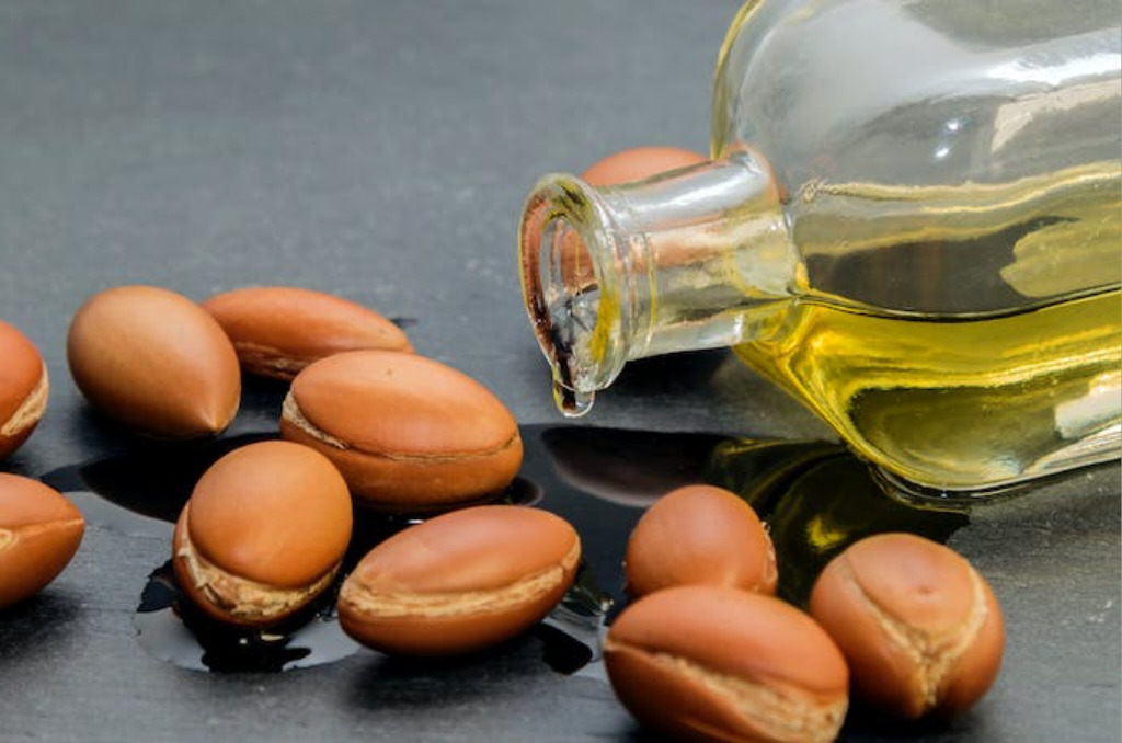 Argan seeds next to bottle of argan oil, the top of the natural moroccan beauty secrets