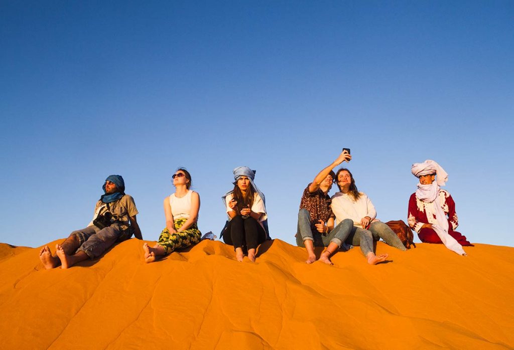 Infinite Morocco Tours: Custom Travel Done Right 14 Group of people in a Moroccan desert.